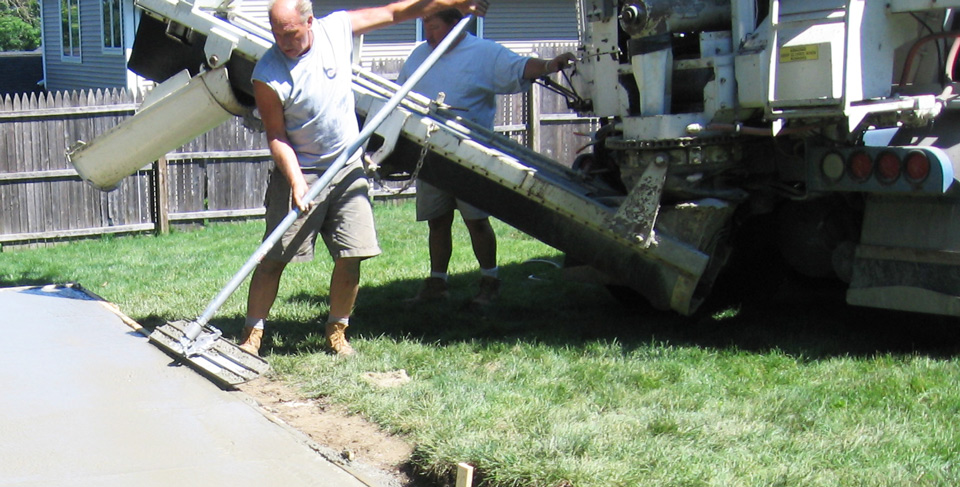 Pouring and smoothing concrete for an outdoor residential patio